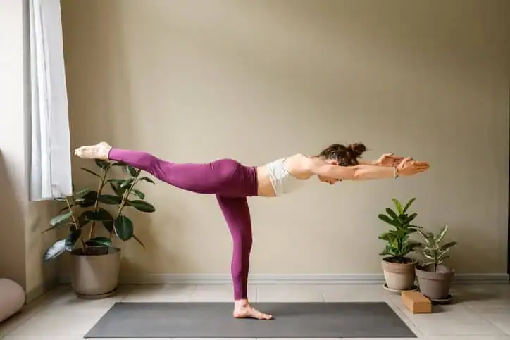 Woman doing Yoga exercise Busby to help with toning the body. 