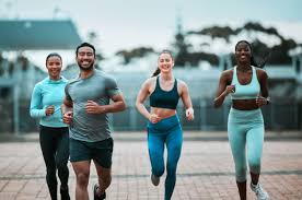 Sculpting Sleek Arms: The Essential Role of Cardio in Toning Without Bulking Up 3 image of people running to incorporate cardio Busby exercise into their life to help tone arms and body.