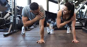 Image of man and woman doing Cardio Busby to tone their arms. 